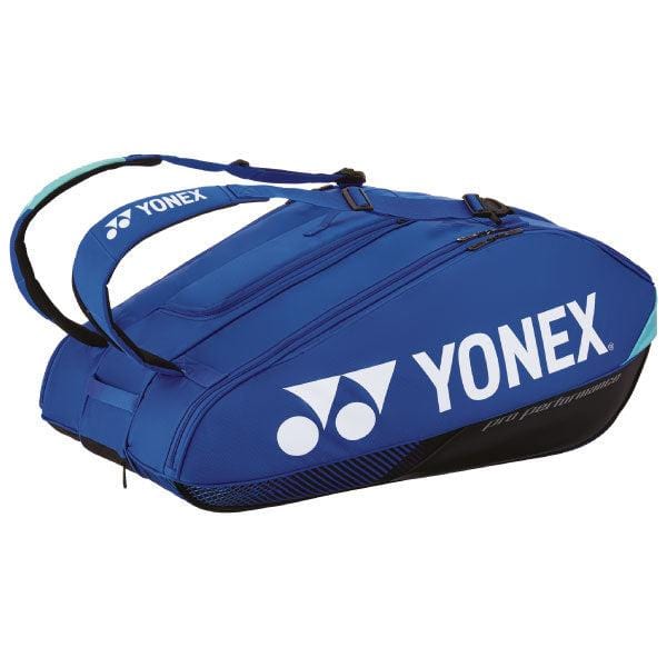 The Yonex 924212EX Pro 12 Racket Tennis Bag in cobalt blue, featuring multiple racket compartments and a sleek white logo, offers double shoulder straps for easy carrying of racquets and sports equipment.