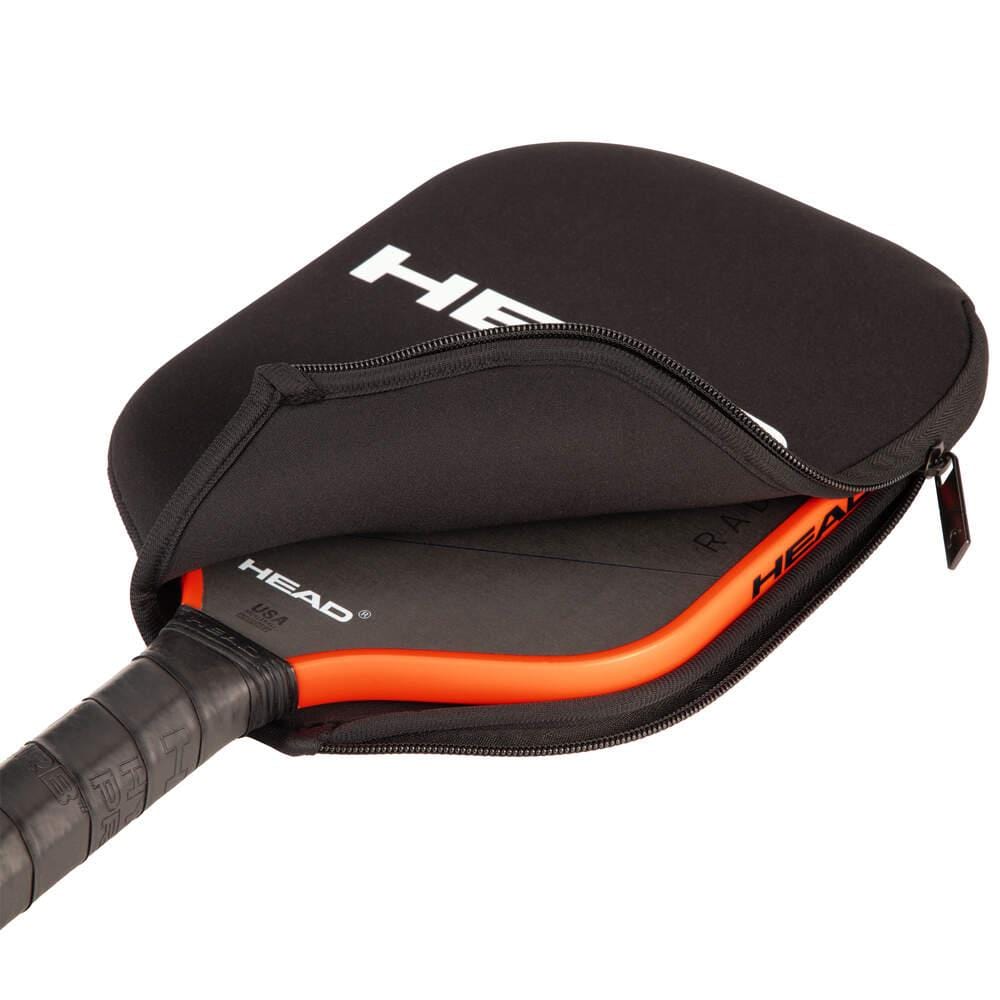 A black and orange HEAD pickleball paddle is partially zipped inside the HEAD Pickleball Paddle Coverbag - Black, with the handle and edge visible.