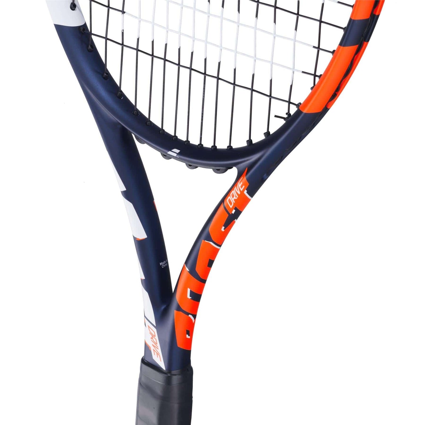 A close-up of the Babolat Boost Drive Tennis Racket shows its black grip, navy blue and orange lightweight graphite frame, and white strings. The design features bold patterns highlighted by the Woofer System, displayed against a white background.