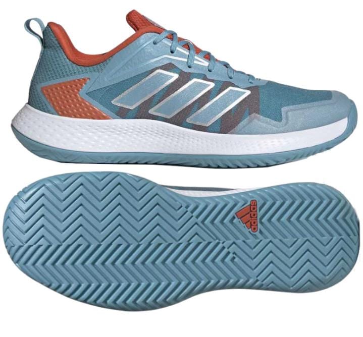 These adidas Defiant Speed Women's Tennis Shoes in blue boast a lightweight mesh upper and showcase vibrant orange accents paired with white soles. The geometric pattern and herringbone tread enhance both style and functionality, while the iconic adidas logo is prominently displayed on the sole.