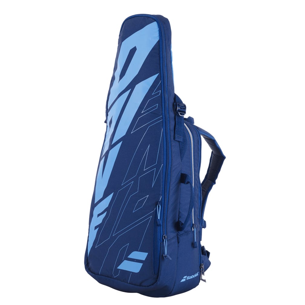 Introducing the Babolat Pure Drive Tennis Backpack - Blue: a stylish blue tennis bag featuring striking light blue lettering. This backpack, crafted by Babolat, is perfect for carrying your tennis essentials and boasts multiple compartments including an isothermal insulated section to keep your rackets and gear organized and cool.