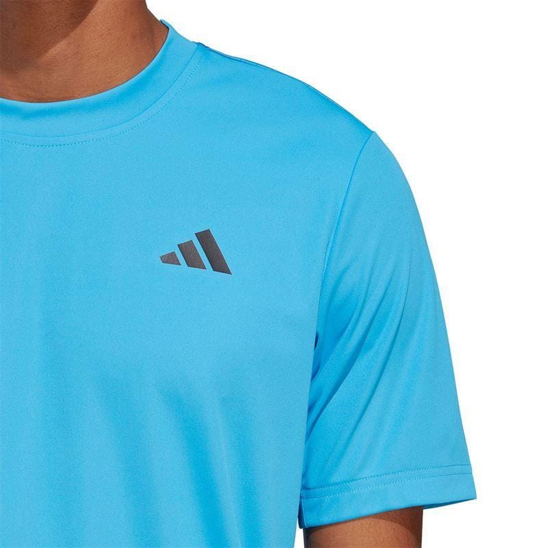 A person wearing an ADIDAS Men's Club Tennis T-Shirt in Pulse Blue, with a small logo featuring three diagonal stripes on the chest. The AEROREADY fabric ensures comfort and style, set against a plain white background.