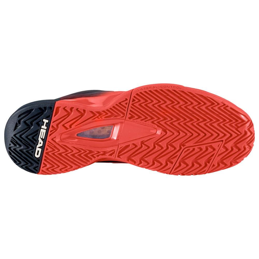 The image features the sole of the HEAD Revolt Pro 4.0 Mens Tennis Shoes - BBFC, exhibiting a red zigzag pattern with a small transparent area in the center. The brand name "HEAD" is prominently displayed in white text on the heel, emphasizing its advanced performance technologies.