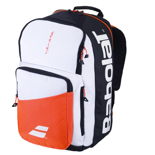 The Babolat Pure Strike Tennis Backpack, branded with "Babolat," boasts a sleek design in white and black with striking red accents. Crafted from recycled polyester, this tennis backpack offers multiple zippered compartments for efficient organization.