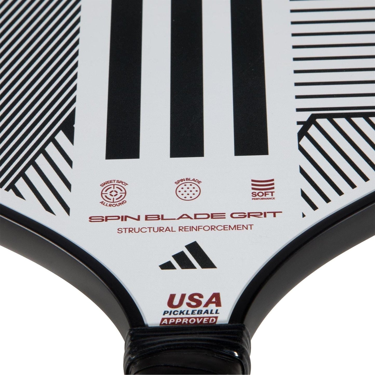 Close-up of the adidas ADIDAS Match Light 3.3 Pickleball Paddle in white with black geometric lines, "Spin Blade Grit," "Structural Reinforcement," and "USA Pickleball Approved"—ideal for beginners, featuring adidas and other logos.