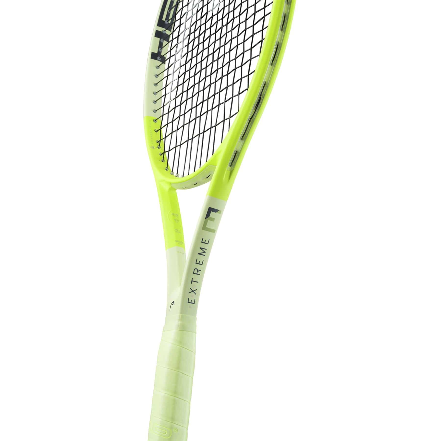 An eye-catching bright yellow and white HEAD Extreme Pro 2024 Tennis Racket features black strings with the word "EXTREME" boldly printed on its frame. It boasts spin control and Auxetic 2.0 technology. The racket, with a light green grip, is angled to magnificently showcase the handle and lower frame in stunning detail.