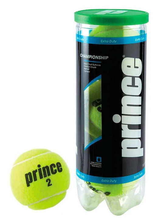 A tube of Prince Championship Tennis Balls - 3 Ball Tube by Prince with a green lid stands beside a yellow ball marked "prince 2." The clear packaging shows additional balls inside, designed for tournament-level hard court play.
