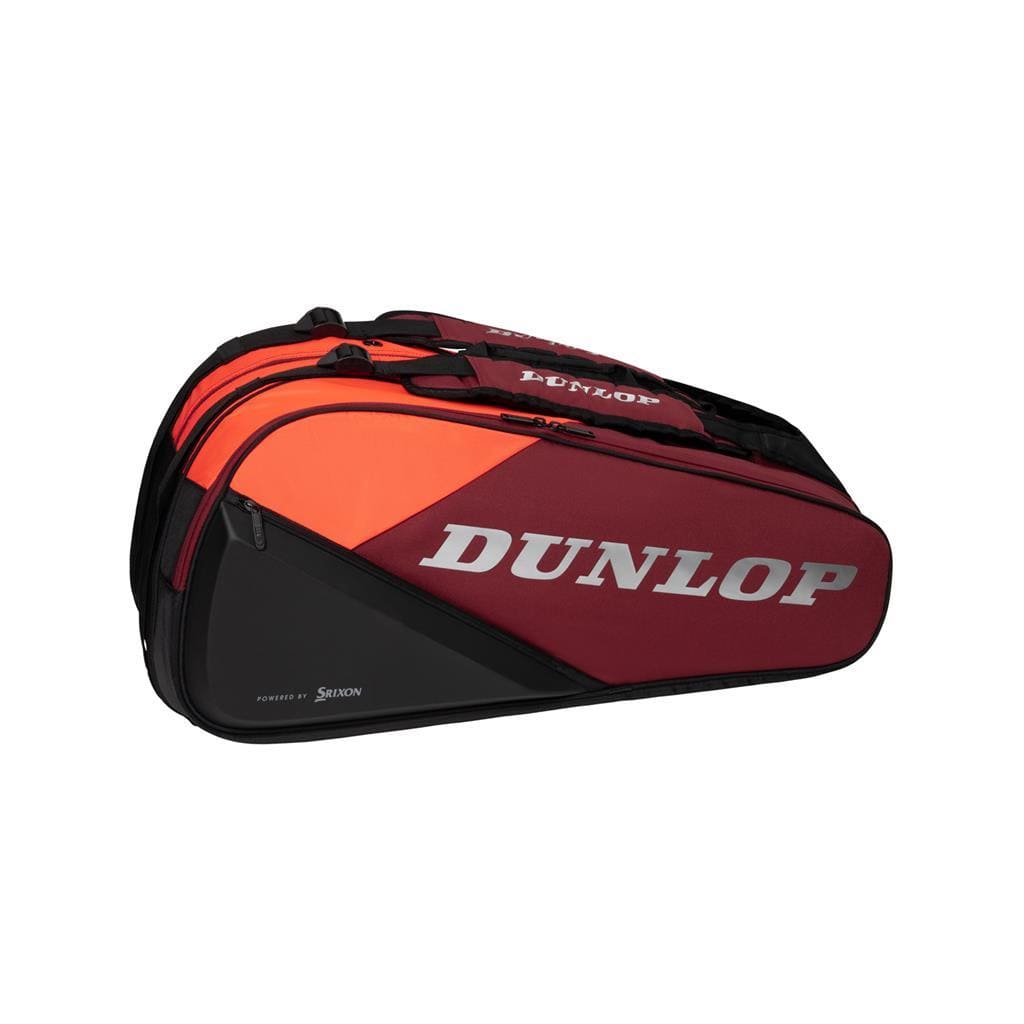 This black and red Dunlop CX Performance 12 Tennis Racket Bag prominently displays the brand name in large white letters. It features multiple compartments, including a ventilated shoe compartment, and ergonomic padded shoulder straps for easy carrying.