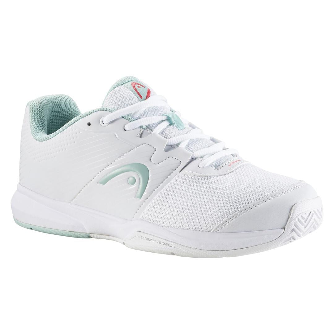 The HEAD Revolt Court Women's Tennis Shoes in White and Grey are perfect for tennis, featuring a lightweight design with a mesh upper for breathability. The shoes have laces for closure and a cushioned insole to ensure ultimate comfort. They boast a textured sole, along with subtle light green accents. The unmistakable HEAD logo is prominently displayed on the side and tongue of the shoe.
