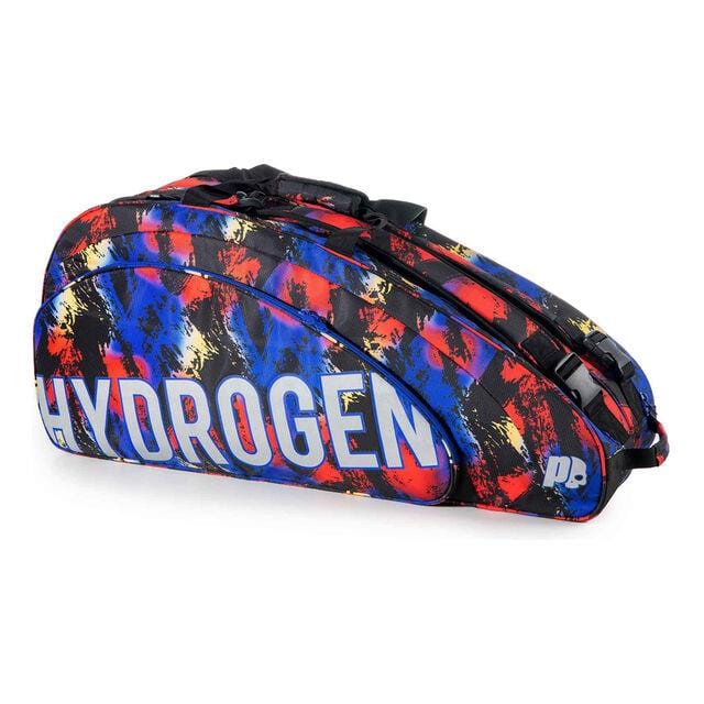 The Prince Hydrogen Random 9 Racket Tennis Bag - Blue / Red / Multi is a vibrant tennis bag adorned with an abstract design featuring brush strokes in blue, red, and yellow. It includes adjustable shoulder straps and prominently displays the word "HYDROGEN" in white on the side, complemented by a small white logo on the bottom right corner.