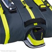 A close-up of a grey and yellow sports bag, reminiscent of the Babolat RHX12 Pure Aero Tennis Racket Bag by Babolat, with a compartment unzipped to reveal a pair of sports shoes inside. The bag features several zippers and handles, offering ample storage space for all your essentials.