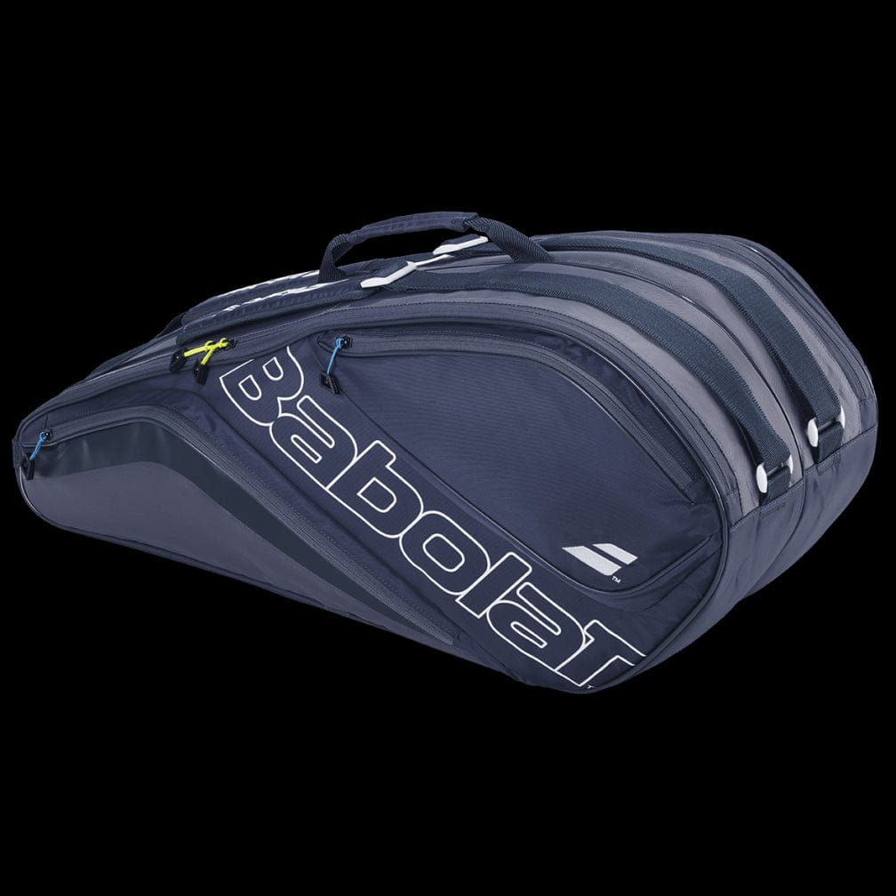 The Babolat Evo Court L Tennis Racket Bag in grey and blue is crafted from durable, recycled materials. It features multiple compartments and a convenient top handle, with the brand name prominently displayed on the side in large white letters.