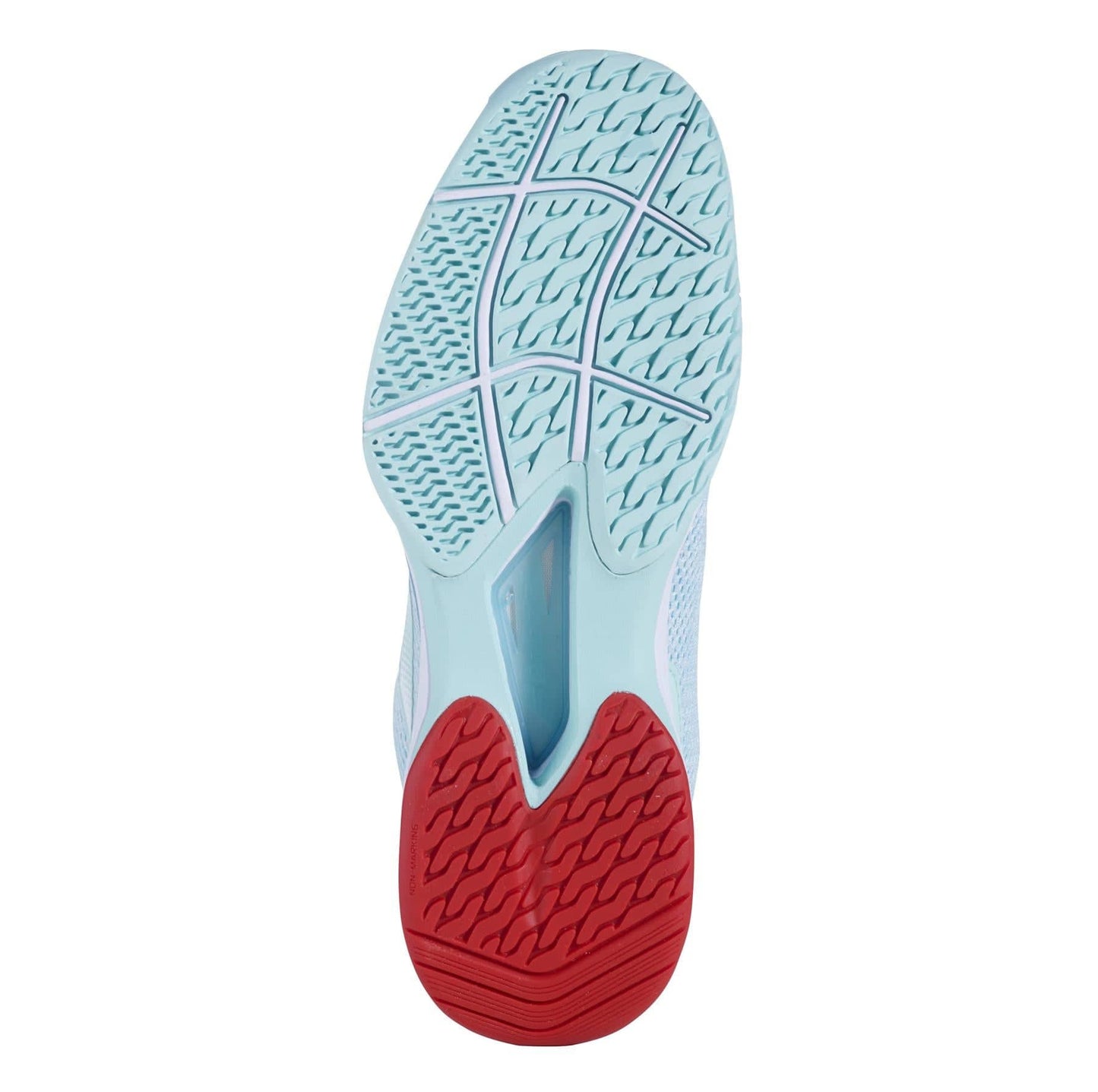 The image highlights the sole of the Babolat Jet Tere All Court Women's Tennis Shoes in Yucca and White, featuring an intricate tread pattern and a contrasting red heel section that incorporates the KPRS-X System for improved grip and durability.