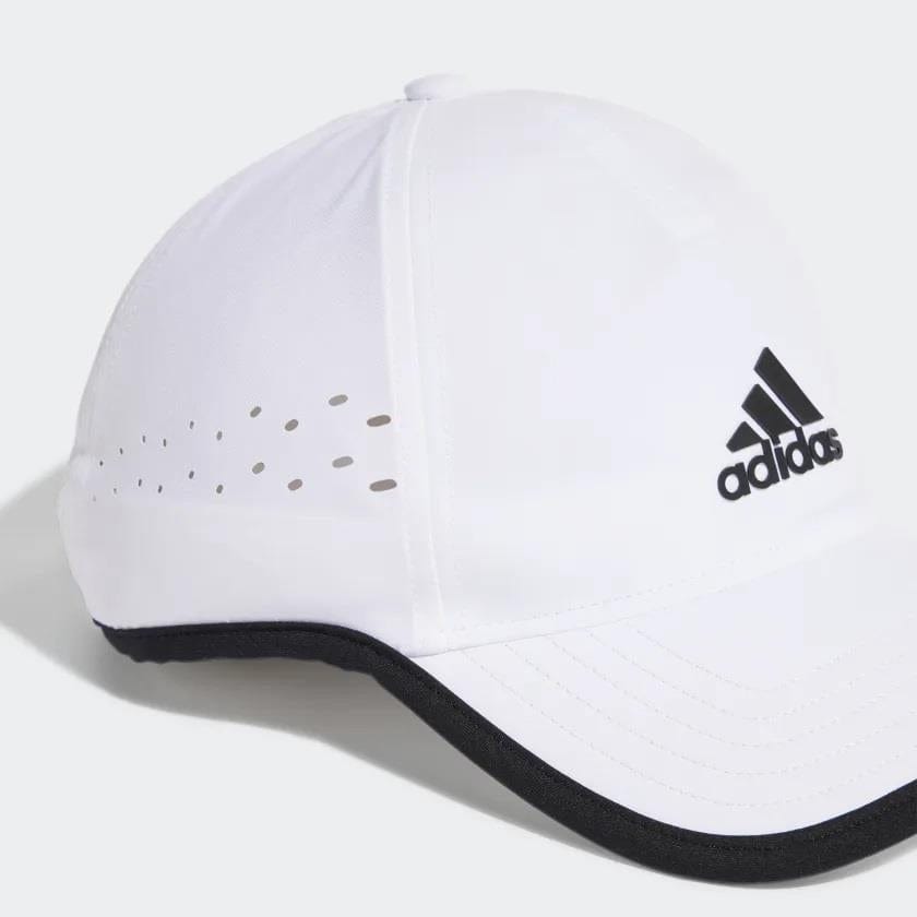 The adidas Aeroready Baseball Cap, offered in white, incorporates Parley Ocean Plastic and showcases the classic black logo on the front. Prioritizing comfort, it features moisture-absorbing fabric and side perforations for ventilation, enhanced by a sleek black trim on the brim.