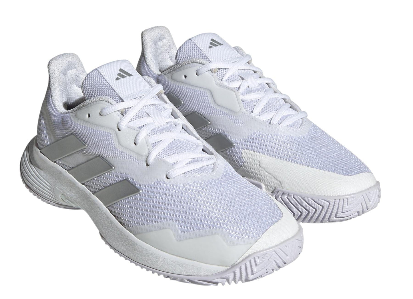 Introducing the adidas Courtjam Control Women's Tennis Shoes in Cloud White and Silver Metallic, designed with a minimalist and contemporary style. These shoes showcase a white athletic aesthetic with silver accents and a textured sole. Featuring a mesh upper for superior breathability, they are displayed at an angle and incorporate adidas' CourtJam Control technology for optimized performance on all surfaces.
