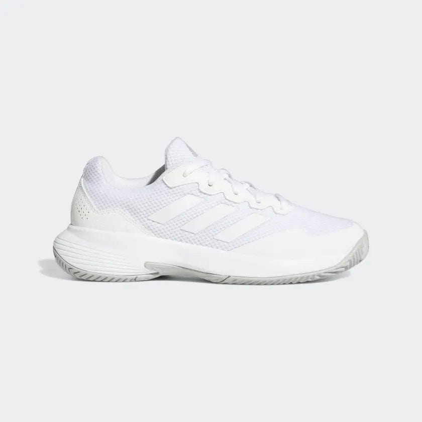 The adidas GameCourt 2 Women’s Tennis Shoes in white feature a textured sole and breathable mesh upper, ideal for hard court play. The shoe displays three signature stripes along the side and is stylishly set against a light gray backdrop.