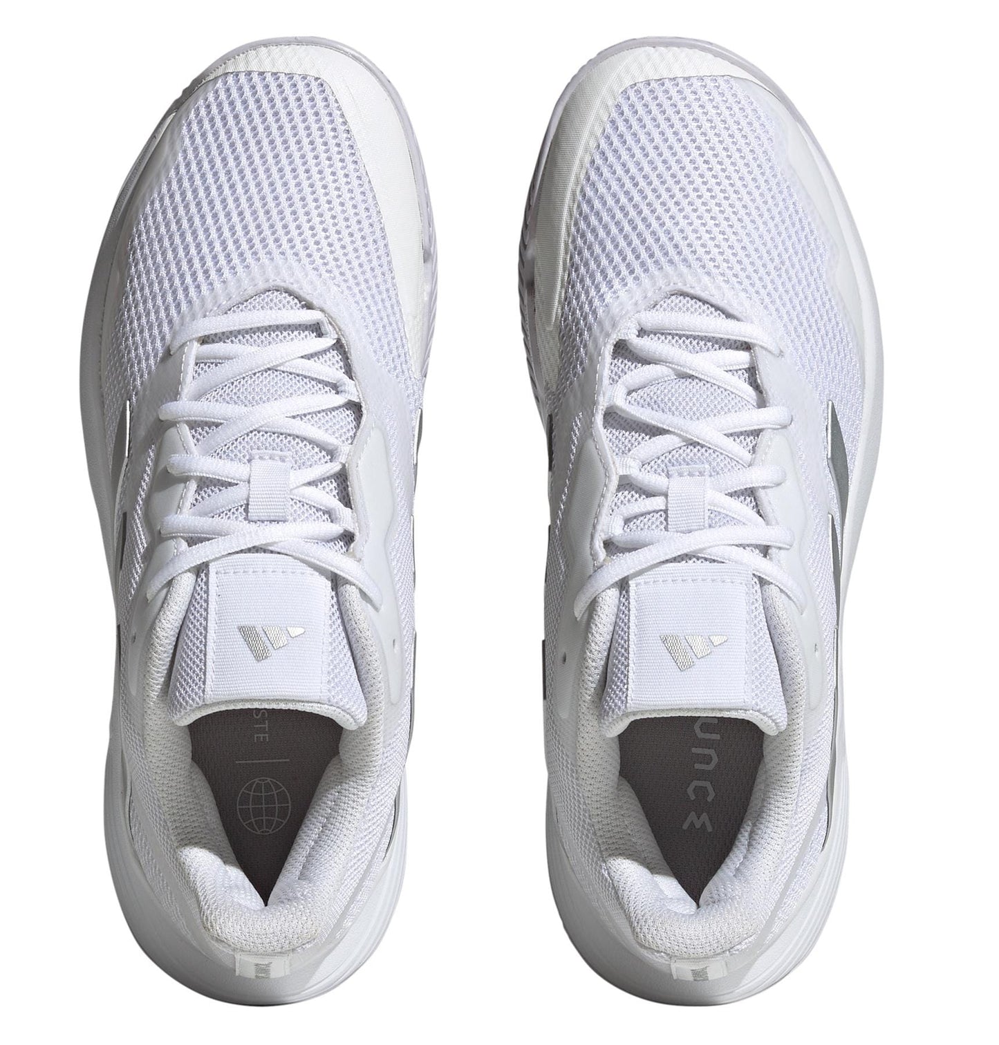 The adidas Courtjam Control Women's Tennis Shoes in Cloud White and Silver Metallic feature mesh uppers, a top-down view reveals lace-up closures, a textured sole with a hard court outsole, and subtle geometric patterns on the sides and tongues for improved performance.