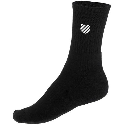 Displayed against a white backdrop is one of the black cotton socks from the K-Swiss TAC Hypercourt Sports Socks (2 Pack). It showcases a ribbed texture with a small white shield logo on the upper side, capturing the high quality synonymous with K-Swiss sportswear.