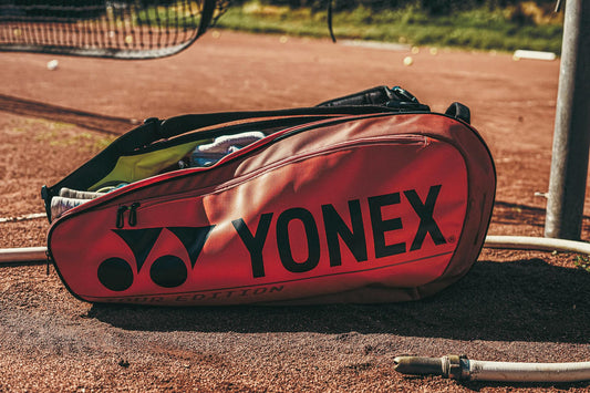 Yonex tennis bag on a clay court