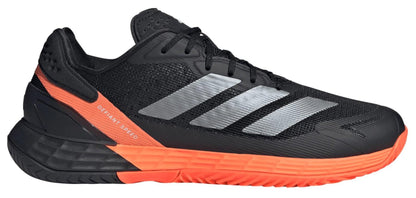 The adidas Defiant Speed 2 Men's Tennis Shoes in Black/Orange feature silver stripes, black laces, an orange midsole/heel, a textured sole, and "DEFIANT SPEED" written near the heel.