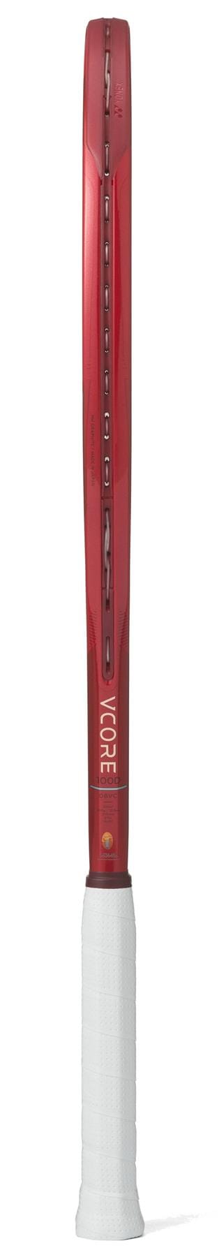 Side view of the Yonex VCORE 100D Ruby Red 2026 tennis racket with a white grip, showcasing its slim frame, string pattern, and excellent spin potential.