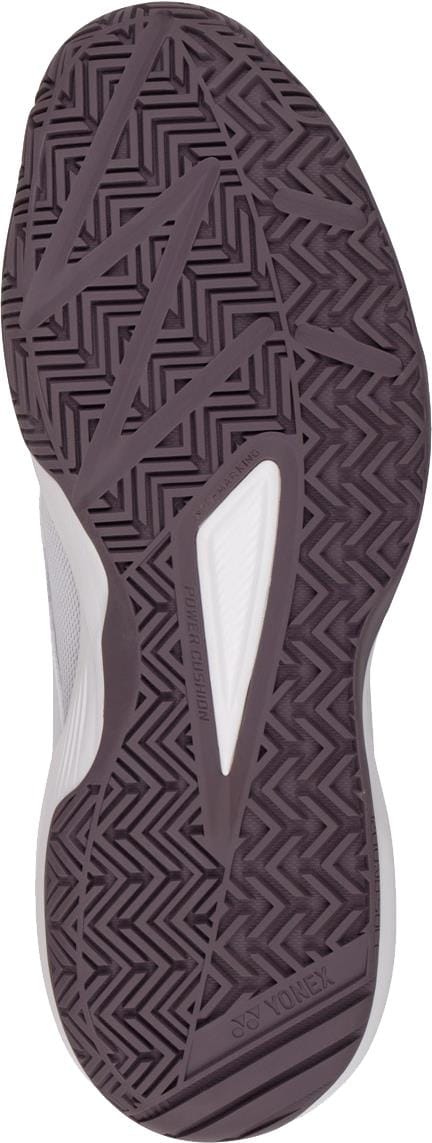 Close-up of the Yonex Pro-Move Classic WIDE Men's Tennis Shoes (White/Red) sole shows a dark zigzag herringbone tread with white accents for superior grip. Enjoy stability and lightweight comfort, powered by Yonex’s innovative Power Cushion technology.