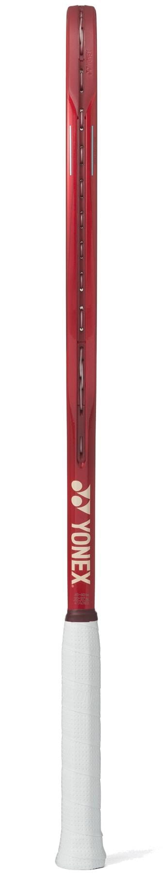 The Yonex VCORE 98 Ruby Red 2026 Tennis Racket is shown from the side, highlighting its slim frame and white grip. "MORE" is printed vertically on the shaft, emphasizing spin potential.