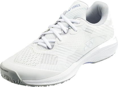 The Yonex Power Cushion Sonicage Women's Tennis Shoes in White/Grey are shown angled to display the side and front, featuring a textured upper, grey lining, white laces, and grooved rubber sole for lightweight comfort in every match.