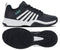A pair of K-Swiss Court Express 2 Men's Tennis Shoes in Carbon, White, and Baltic is shown from the side and bottom. The side view displays bold white stripes against the dark carbon upper with a teal Baltic logo accent, while the bottom view highlights the black textured sole with its detailed tread pattern. Featuring a cushioned midsole for enhanced comfort, these stylish and functional tennis shoes embody classic K-Swiss design.