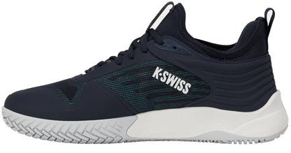 The K-Swiss Hypercourt Pinnacle Men's Tennis Shoe in Carbon, White, and Baltic is displayed in a left side profile view against a white background, showcasing its navy blue upper with a white sole and "K-SWISS" written in white on the side.