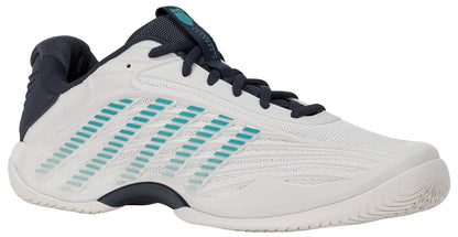The K-Swiss Hypercourt Express 3 Men’s Tennis Shoes in White, Carbon, and Baltic feature a mesh upper with teal and navy accents, blue diagonal stripes on the side, and a textured sole. Designed for court performance, these shoes include a responsive Surgelite+ Midsole for enhanced comfort. The laces, tongue, and heel area are finished in dark navy.