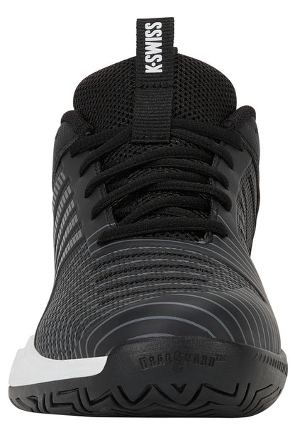 A front-facing view of the K-Swiss Ultrashot Light Men's Tennis Shoe in Moonless Night, White, and Gold showcases its black upper with a white sole, black laces, and “K-SWISS” branding on the tongue against a crisp white background. Engineered for lightweight performance and comfort on the court, this shoe is an excellent option for tennis players.