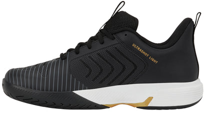 Introducing the K-Swiss Ultrashot Light Men’s Tennis Shoes in Moonless Night, White, and Gold. With a sleek black design complemented by a white sole and gold accents, these lightweight court shoes deliver optimal performance. The breathable mesh upper and bold striped detailing offer both style and support, making them an excellent choice for players searching for reliable and fashionable tennis footwear. "ULTRASHOT LIGHT" is prominently printed on the side as a mark of quality from K-Swiss.