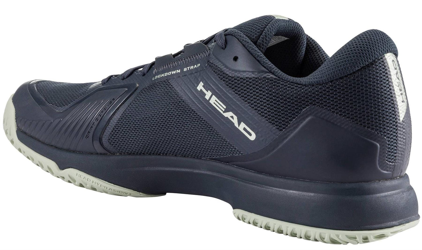 The HEAD Sprint Team 4.0 Men's Tennis Shoes in Navy/Cantaloupe Green feature breathable mesh and synthetic uppers, the HEAD logo on the side and heel, a "LOCKDOWN STRAP" label, and a textured light gray outsole for excellent grip.