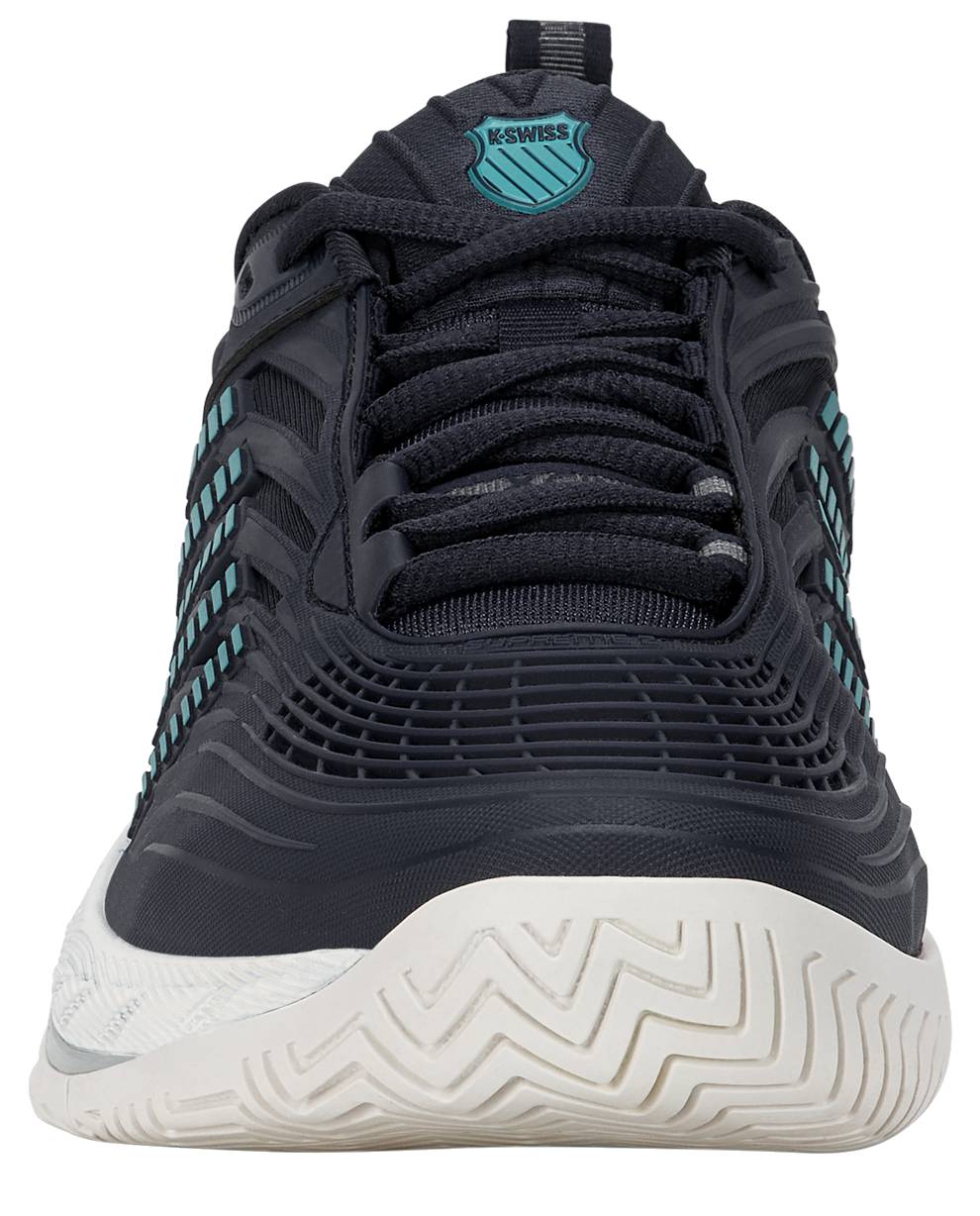 A close-up front view of the K-Swiss Hypercourt Supreme 2 Men's Tennis Shoes in Carbon, White, and Baltic, featuring dark navy blue coloring with light blue accents, a white sole, and the K-Swiss logo on the tongue. These high-performance tennis shoes are designed with a durable Dragguard outsole for enhanced durability on the court.