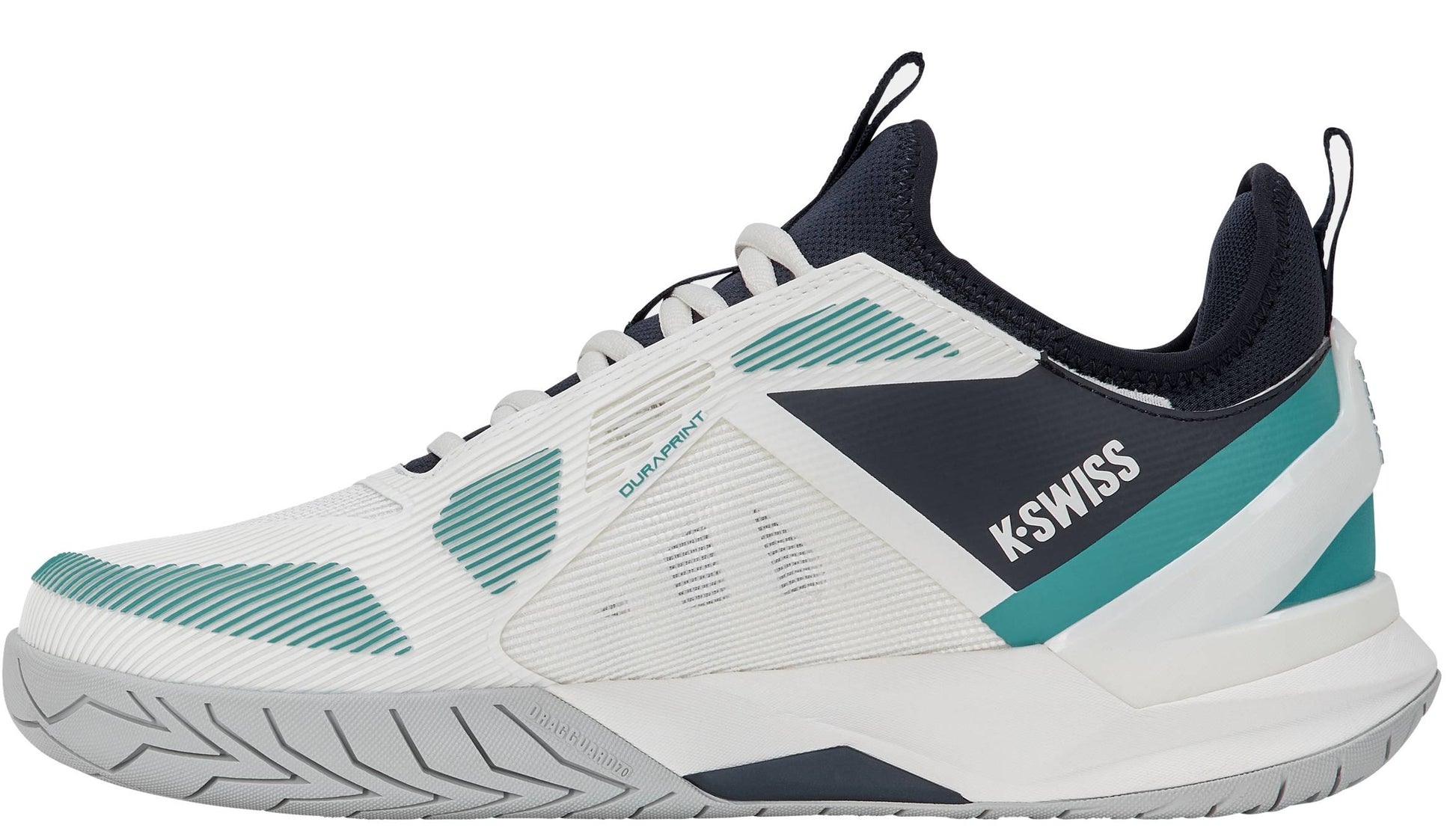 The K-Swiss K-Frame Speed Rublo Men's Tennis Shoes in White, Carbon, and Baltic feature athletic styling with teal and navy accents, a textured sole, and prominent "K-Swiss" branding on the side. The design includes mesh panels for breathability, plus a black tongue and collar. These shoes incorporate the signature K-Frame support technology—favored by pros like Andrey Rublev—for enhanced stability on the court.
