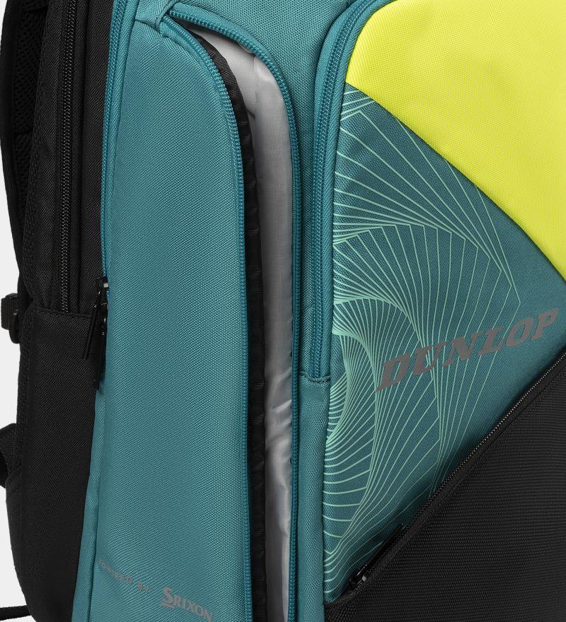 Close-up of the Dunlop SX Performance Tennis Backpack, perfect for serious players. It showcases a teal, black, and yellow color scheme with a partially open compartment highlighting its functionality. The "Dunlop" brand name shines in silver on a stylishly patterned section.