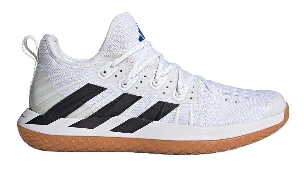 The ADIDAS Stabil Next Gen Primeblue Men's Indoor Shoes in Cloud White and Core Black are designed by adidas, featuring a breathable mesh upper with signature black stripes, white laces, and a gum rubber sole. These shoes incorporate energy return technology and have a loop at the heel, offering a sleek design perfect for sports activities and indoor court use.