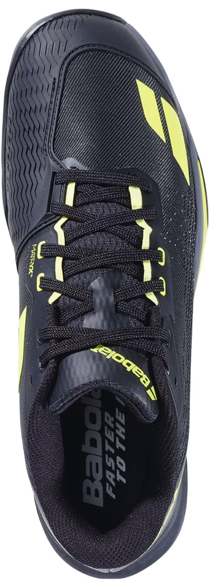 The Babolat Jet Mach 4 All Court Men's Tennis Shoe in Black/Aero features yellow accents, "Babolat" branding on the side and insole, black laces, a textured toe area, and is designed for agility.