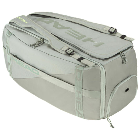 The HEAD Pro Tennis Duffle Bag L LNLL is a large, light gray bag featuring the "HEAD" logo in bold. It comes with sturdy handles, a zippered top, side pockets, and adjustable shoulder straps. Inspired by Matteo Berrettini's style, its sleek design and spacious interior make it perfect for travel or sports.