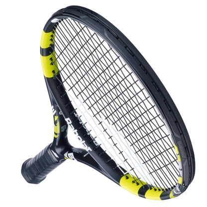 The Babolat Evoke Tour 2026 Tennis Racket is shown at an angle, highlighting its black and yellow design, white grip, tightly strung strings, and aerodynamic frame.