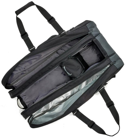 The Yonex BA72629EX Gearlogic 9 Racket Tennis Bag in black is shown open, displaying a spacious main compartment with an inner zippered pocket. It features two long adjustable shoulder straps and is empty.