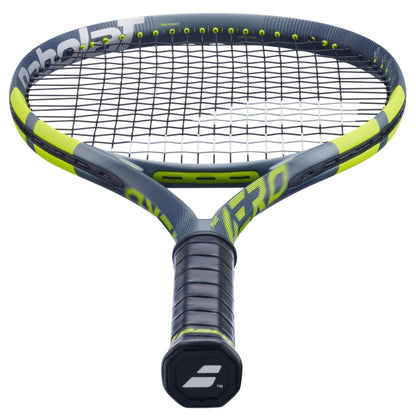 A close-up of the Babolat Pure Aero 2026 Tennis Racket showcases its black grip tape, tightly strung head, and the Babolat logo visible on the handle end.
