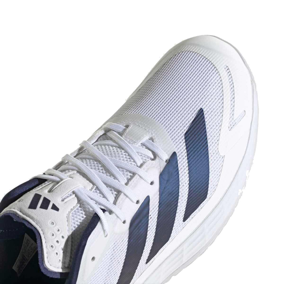 Close-up of adidas Defiant Speed 2 Men's Tennis Shoes in white/navy, featuring navy stripes and laces, a textured mesh upper, and thick white sole. Lightweight design ensures comfort and high performance on the court.