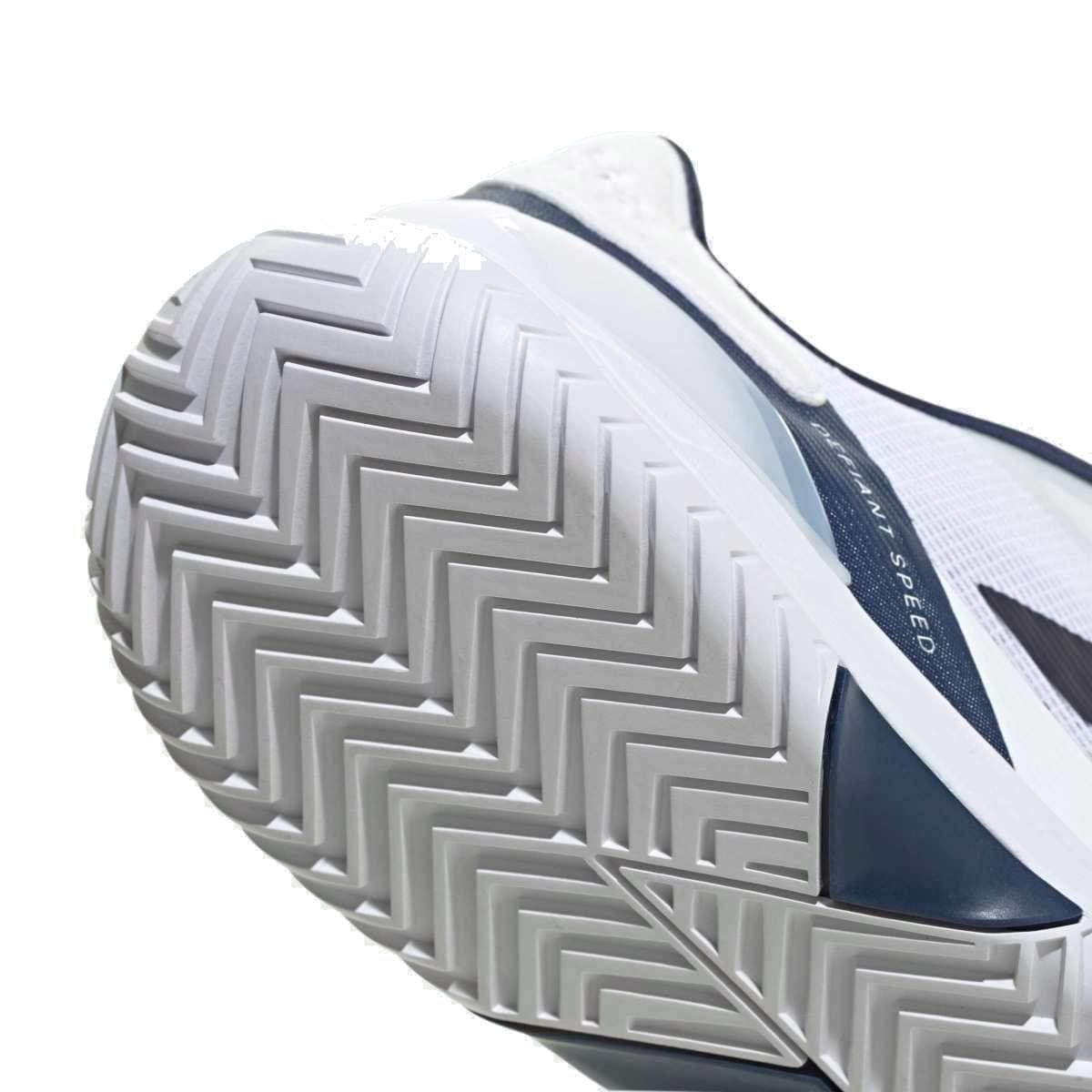 Close-up of the adidas Defiant Speed 2 Men's Tennis Shoes in White/Navy, showcasing the herringbone tread on the sole for traction and a dark side strip with partially visible text.