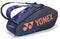 The Yonex 92426EX 6 Racket Pro Tennis Bag in Midnight Navy features orange branding, geometric blue side patterns, two shoulder straps, and holds up to six rackets—combining style and function for tennis players.