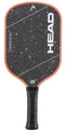 The HEAD Radical Tour EX15 2026 Pickleball Paddle features a black design with orange trim, prominent white HEAD branding, and a textured speckled surface. Its black handle is wrapped for a secure grip, and the paddle’s thermoformed construction offers enhanced durability and high-level performance on the court.