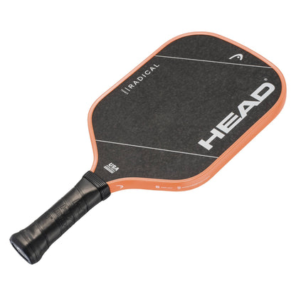 The HEAD Radical Team 15 2026 Pickleball Paddle by HEAD is black with striking orange edges. It features a textured face, a black wrapped handle, and distinctive white diagonal lines along with the bold "HEAD" logo in white. Engineered with an advanced TriFlex core, this paddle delivers enhanced performance on the court.