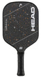 The HEAD Radical Pro 15 2026 Pickleball Paddle is a black paddle from HEAD, featuring a TriFlex Versatility Core and a textured, raw carbon surface. It is accented with white diagonal stripes, orange specks, and has a black grip. Both the HEAD logo and the USA Pickleball logo are visible on the paddle.