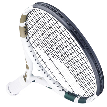 A close-up of the Babolat Boost Wimbledon 2025 Tennis Racket in white and champagne green, featuring a sleek design and tightly strung black strings, angled upward against a plain white background—boost your game with Babolat.
